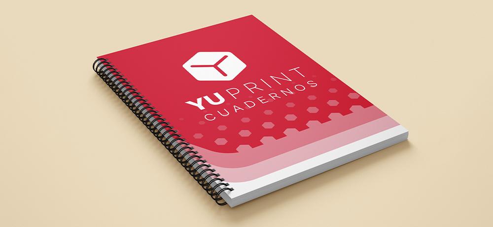 Cuaderno corporativo Yuprint con portada roja y espiral, perfecto para branding y uso diario.
