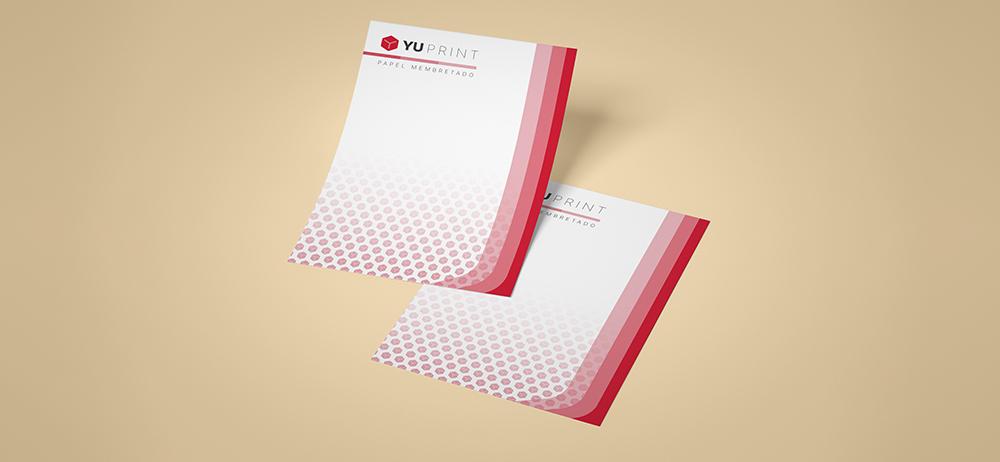Papel membretado Yuprint con diseño corporativo en tonos rojos, ideal para documentos profesionales.